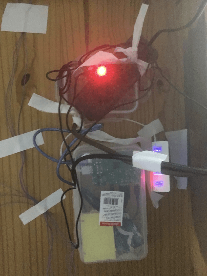 The Arduino and Raspberry Pi units taped beneath the table