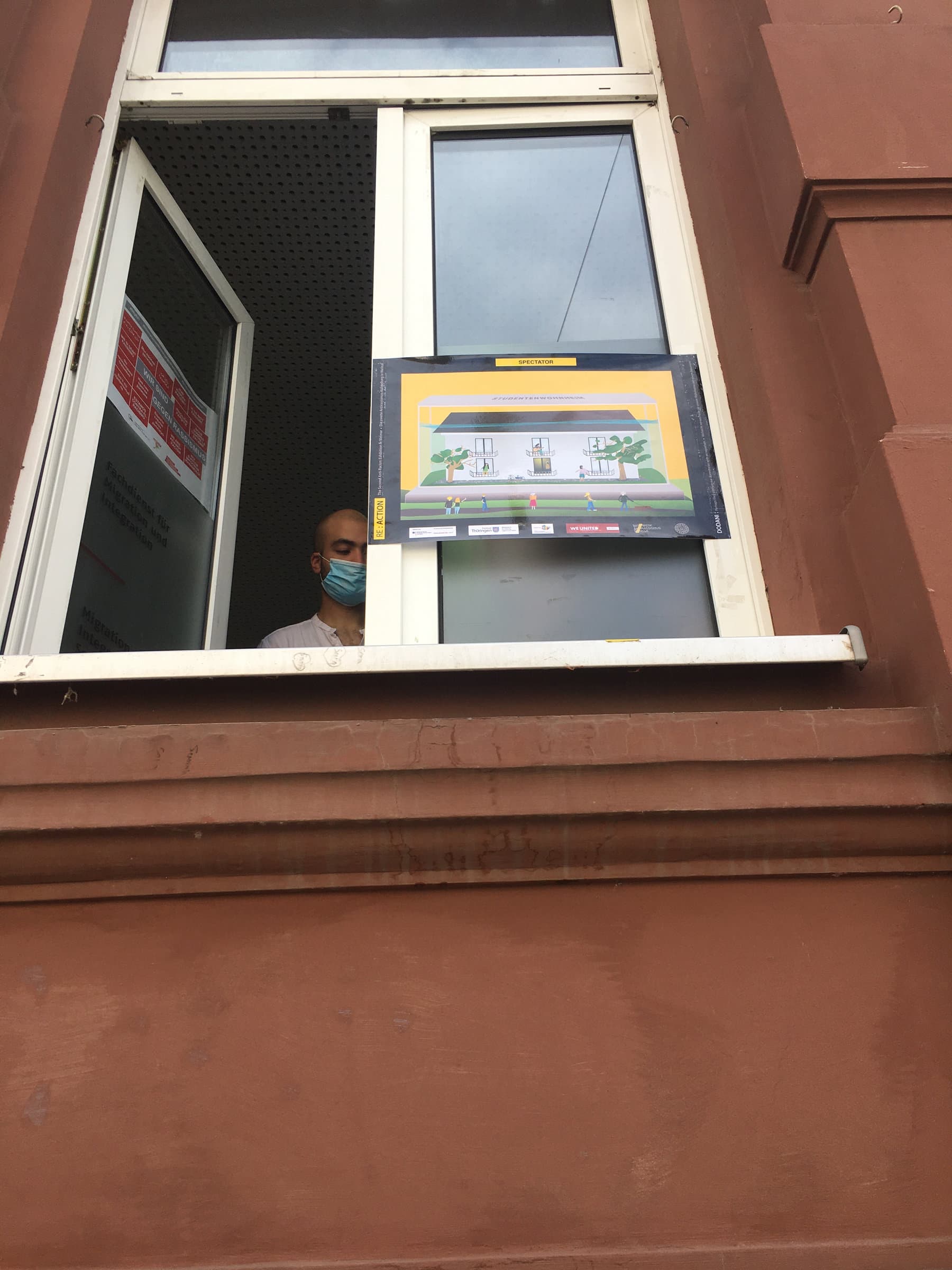 The Spectator poster displayed in a window during the exhibition